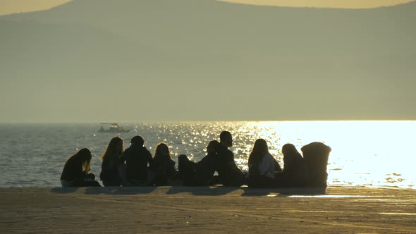 People sitting on a quay  alt