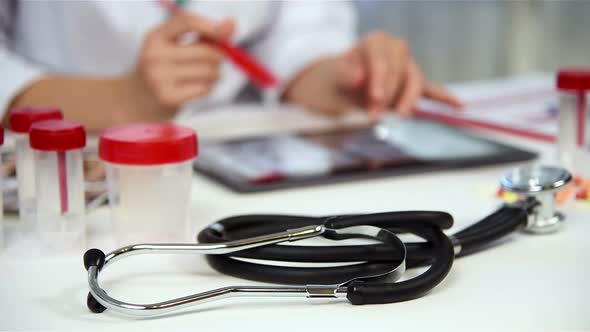 Doctor Examines An X-ray Of The Patient alt