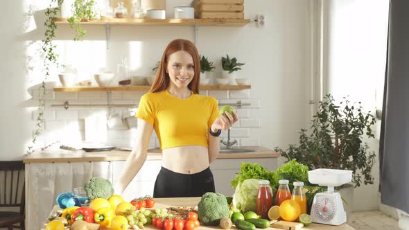 Woman Stands at a Table with a Lot of Vegan Food Ingredients She Talks About Proper Nutrition at