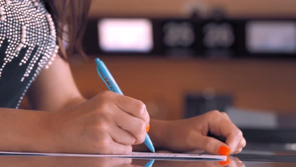 Female Hands Fills Out Documents Medical Questionnaire at the Airport alt
