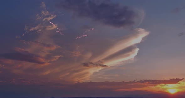 There is a Fireworks Display That Takes Place During Sunset of the Celebration of the Holiday in the alt