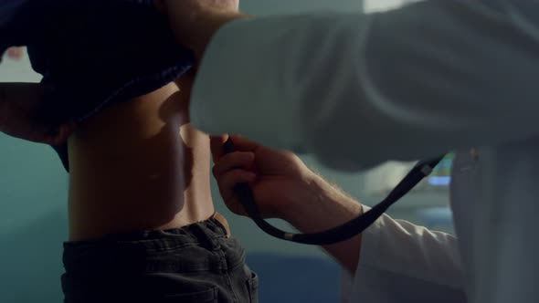 Physician Listening Lungs Teen Girl Using Stethoscope at Medical Examination alt