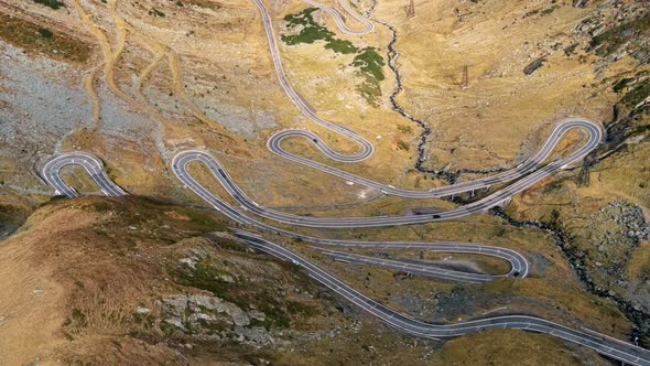 Aerial drone view of nature in Romania. Transfagarasan route with cars in Carpathian mountains alt