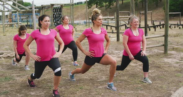 Female friends enjoying exercising at boot camp together alt