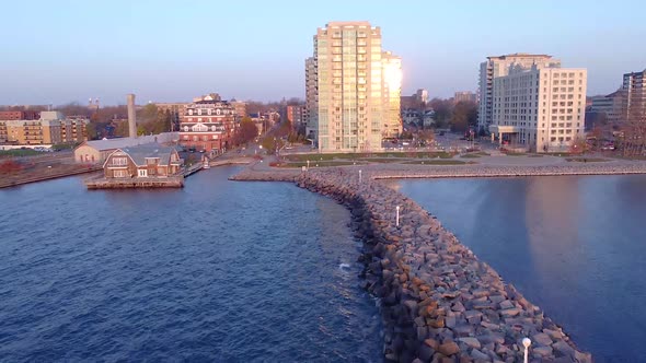 aerial going towards city waterfront during sunrise alt