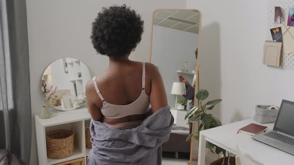Curvy African American Woman Dancing in front of Mirror alt