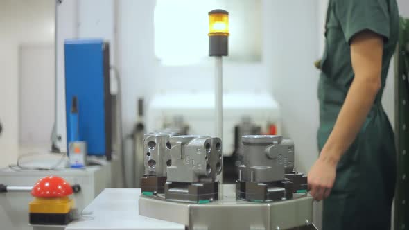 Factory Worker Taking Industrial Unit From Conveyor. Quality Inspection alt