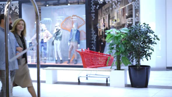 Adult Caucasian Couple Strolling in Shopping Center and Stop at Luxurious Shop. Portrait of alt