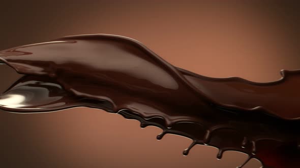 Super Slow Motion Shot of Twisting Chocolate Splash on Brown Gradient Background at 1000 Fps alt