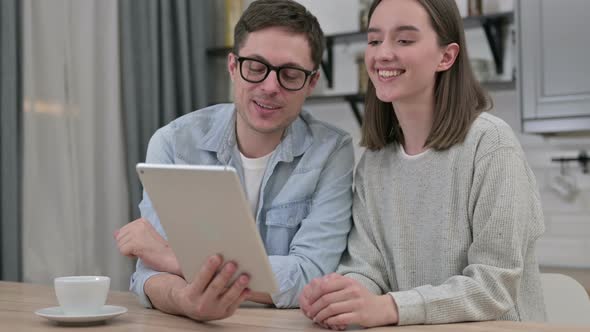 Online Video Chat on Tablet By Couple at Home  alt