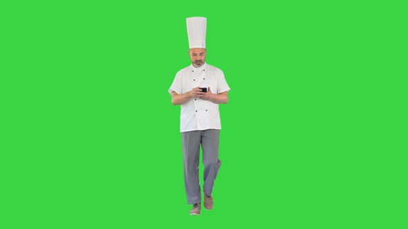Head Cook Walking and Using Mobile Phone on a Green Screen Chroma Key alt