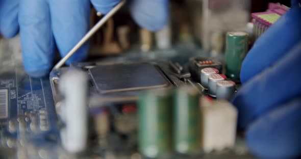 Engineer Repairman Holding Chip Processor CPU in Hands to Insert Into the Socket of the Computer or alt