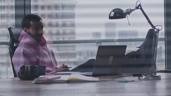 A Young Handsome Man Works in an Office Space alt