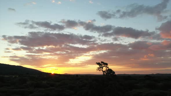 Wide rotating shot of a stunning African sunset alt