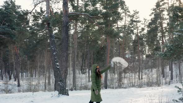 Girl throws up boiling water in the frost in the forest