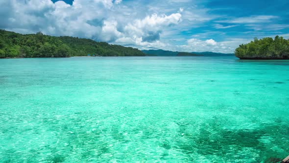Beautiful Blue Lagoon with Pure Clear Water and Rainy Clouds in Background, Gam Island, West Papua alt