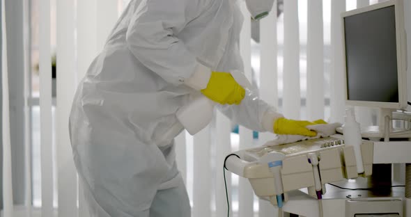 Medical Worker in Ppe Doing Sanitization of Equipment in Hospital Room alt