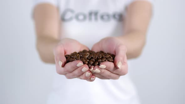Unrecognizable Woman Holding Handful of Coffee Beans alt
