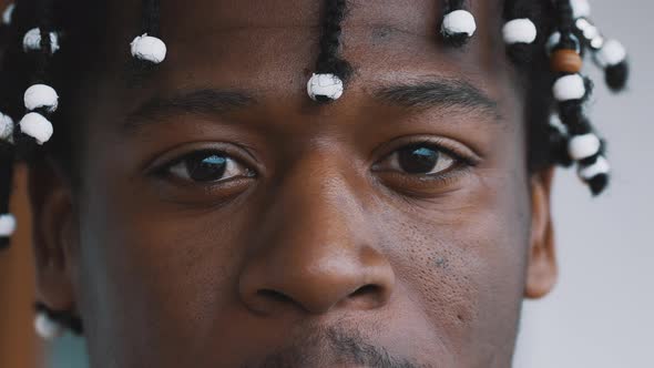 Close Up Eyes of Confident African American Black Man with Braided Hear Looking Into the Camera alt