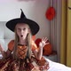 Cute Caucasian Little Girl with Blonde Hair Seven Years Old in Witch Dress and Hat Having Fun and - VideoHive Item for Sale