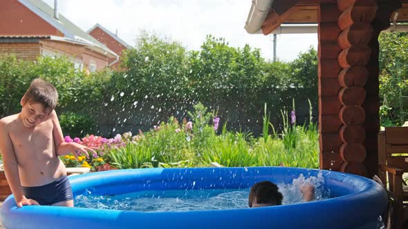 Two boys playing in the pool alt