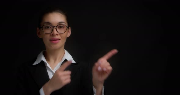 Business Woman Points Her Index Fingers to the Right at an Empty Copy Space