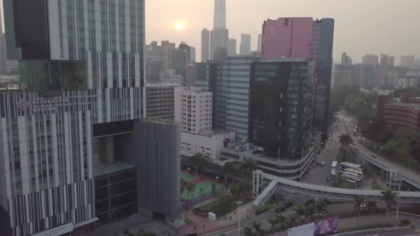 Aerial view Hong Kong city skyscrapers high glass buildings Cars road traffic intersection sunset alt