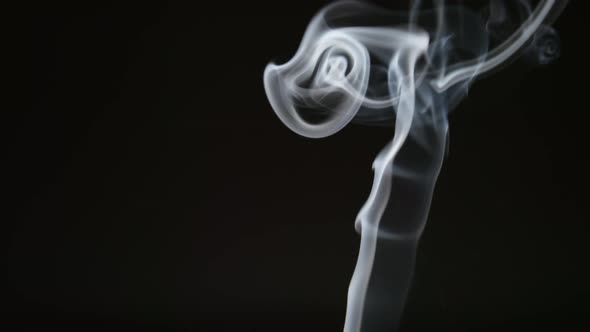 Curly steam of smoke on a black background