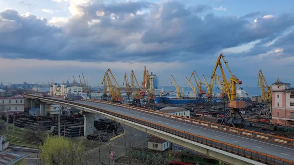 Slow Motion Panning View of Industrial Port with Overpass Road and Cargo Railway Under