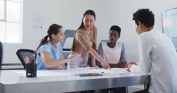 Group of diverse businesswoman talking, smiling and working together in office alt