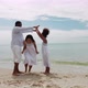 Happy African American family playing together on the tropical beach on vacation - VideoHive Item for Sale