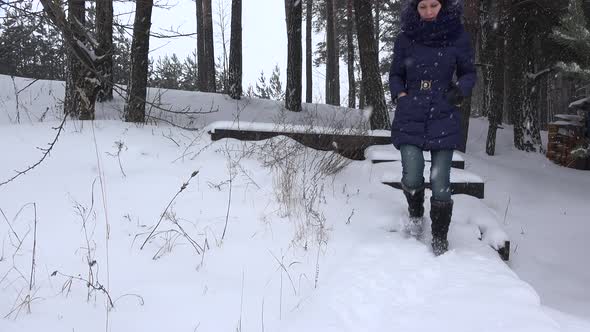 Woman Walk down Stairs Covered with Snow in Winter Park
