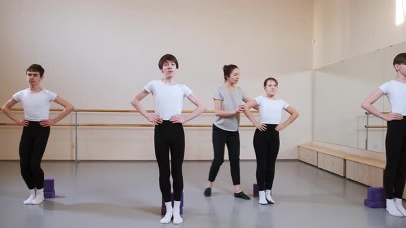 Group of Boys on Ballet Gymnastics Class with Their Teacher Performing Exercise