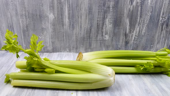 Stalks of celery are on a gray wooden background
