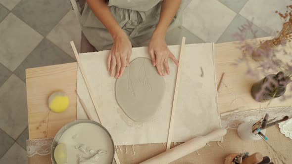 Artisan Making Clay Decoration in Studio