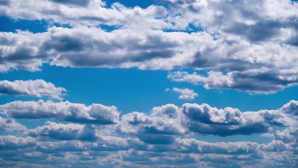 Timelapse of Layered Cumulus Clouds Moving in the Blue Sky alt