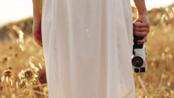 Vintage Cinema Camera on Hand in the Nature alt