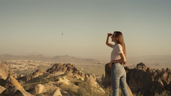 Woman Observing Rocky Formations in Valley of Cappadocia in Morning