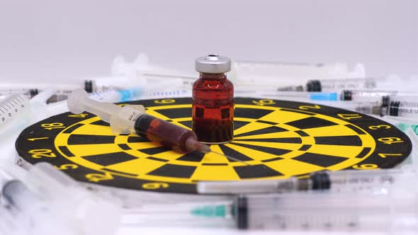 Vaccine bottle with red solution with syringe alt