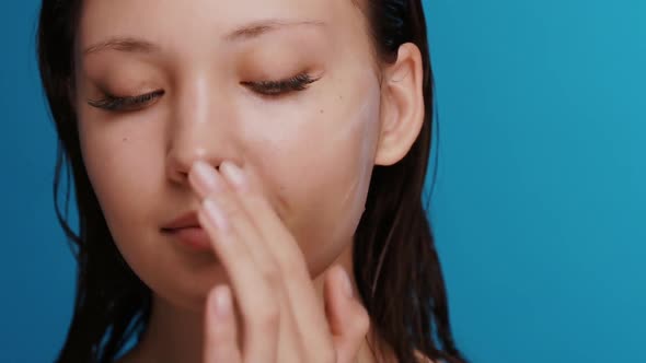 Freash and Clean Girl After Shower Applying Cream and Massaging Cheek with Cream Smiling To Camera alt