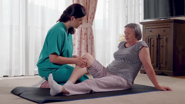 Nurse Giving Leg Massage to Senior Woman