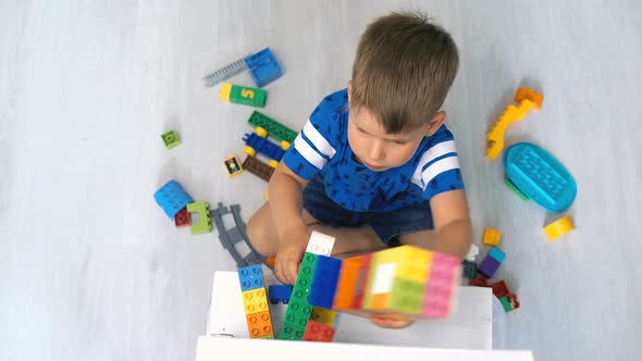 Kid Playing with Logical Toy on Floor in Children Room alt
