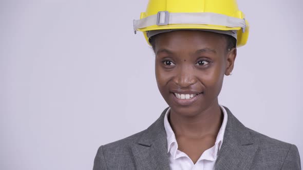 Face of Young Happy African Businesswoman with Hardhat Thinking alt
