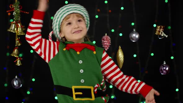 Kid Girl in Christmas Elf Santa Helper Costume Dancing Fooling Around alt