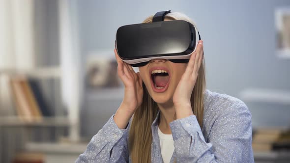Excited Female Gamer Looking Around in Virtual Reality Glasses, Innovation alt