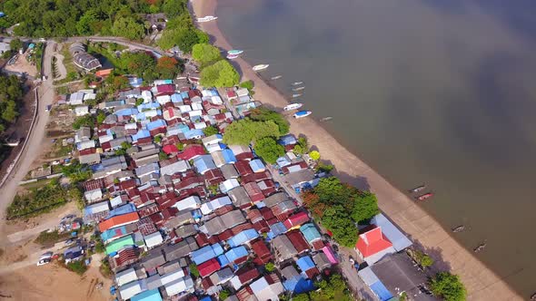 Aerial view of Thai traditional Asian fishing village with boats on sea beach. in Phuket island. alt
