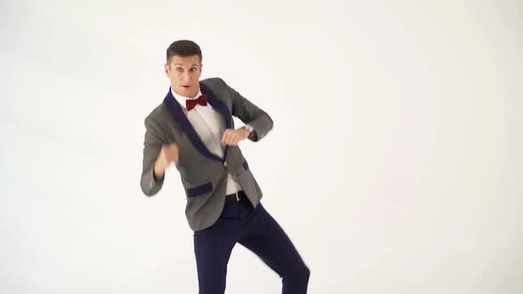 a man in a suit skillfully is copying the movements of a boxer during a fight in the studio. alt