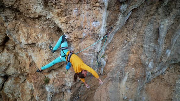 Slow Motion Back View Man Rockclimber Climbs on Overhanging Crag alt