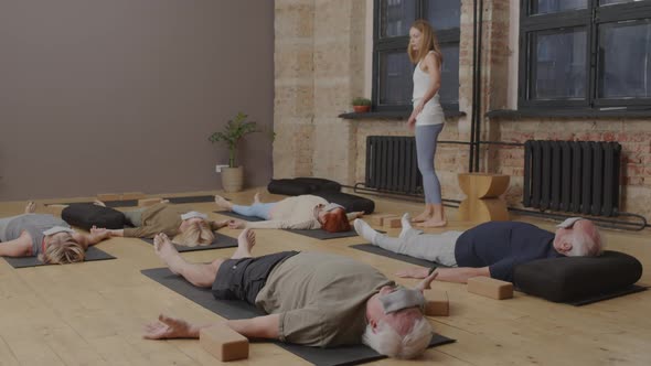 Meditating on Floor in Yoga Studio alt
