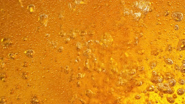 Super Slow Motion Detail Shot of Pouring Beer Into Glass  alt